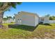 Backyard showing the exterior of the home, a small patio and grassy area at 7210 14Th N St, St Petersburg, FL 33702