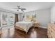 Bright bedroom with hardwood floors, ceiling fan, and French doors leading to the backyard at 7210 14Th N St, St Petersburg, FL 33702
