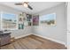 Cozy bedroom features stylish decor, wood-look flooring, and a modern ceiling fan at 7210 14Th N St, St Petersburg, FL 33702