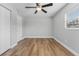 Spacious bedroom featuring wood-look floors, a ceiling fan, and ample natural light at 7210 14Th N St, St Petersburg, FL 33702