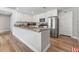Updated kitchen with white cabinets, stainless steel refrigerator and large island with countertop at 7210 14Th N St, St Petersburg, FL 33702