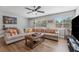 Cozy living room with ample seating, natural light, and wood-look floors at 7210 14Th N St, St Petersburg, FL 33702