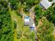 Aerial view of the property showcasing the home's pool, spacious lot, and lush green surroundings at 7211 Red Oak Loop, New Port Richey, FL 34654