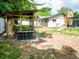Backyard view of a charming home and unique wooden structure perfect for outdoor enjoyment at 7211 Red Oak Loop, New Port Richey, FL 34654