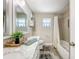 Bathroom featuring modern vanity, framed mirror, and tiled tub/shower at 7211 Red Oak Loop, New Port Richey, FL 34654