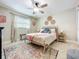 Cozy bedroom with ceiling fan, patterned rug and natural light at 7211 Red Oak Loop, New Port Richey, FL 34654