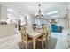 Dining room with kitchen, fireplace, and backyard views at 7211 Red Oak Loop, New Port Richey, FL 34654