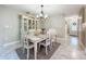 Dining room with white table, chairs, and elegant china cabinet at 7211 Red Oak Loop, New Port Richey, FL 34654