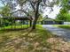 Well-maintained single-Gathering home with carport, mature trees, and a spacious front yard at 7211 Red Oak Loop, New Port Richey, FL 34654