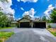 Single Gathering home with large driveway, garage, and stone accents at 7211 Red Oak Loop, New Port Richey, FL 34654