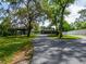 Charming single-Gathering home with spacious front yard, carport, and mature landscaping at 7211 Red Oak Loop, New Port Richey, FL 34654