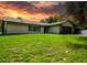 Charming single-story home with a well-manicured lawn, neutral exterior, and a two-car garage and carport at 7211 Red Oak Loop, New Port Richey, FL 34654
