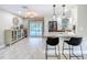Open kitchen with stainless steel appliances and bar seating overlooking the pool, perfect for entertaining guests at 7211 Red Oak Loop, New Port Richey, FL 34654