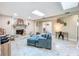 Living room with fireplace, comfortable seating, and bright overhead skylights at 7211 Red Oak Loop, New Port Richey, FL 34654