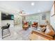 Cozy living room featuring modern furnishings, tile floors, a ceiling fan, and plenty of natural light at 7211 Red Oak Loop, New Port Richey, FL 34654
