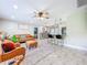 Open concept living room with tile flooring, a ceiling fan, bar seating, and a view into the kitchen at 7211 Red Oak Loop, New Port Richey, FL 34654