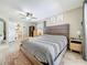 Inviting main bedroom with a comfortable bed, side tables, and access to the bathroom at 7211 Red Oak Loop, New Port Richey, FL 34654
