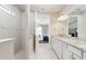 Bathroom boasts double sinks, granite counters, white cabinets, decorative tiling, and a glass-enclosed shower at 7621 Highgrove Ave, Bradenton, FL 34210