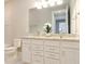 Modern bathroom featuring a dual sink vanity, granite countertops, and a toilet in a separate room at 7621 Highgrove Ave, Bradenton, FL 34210