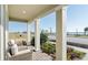 Enjoy stunning lake views from this home's relaxing covered patio with comfortable seating and lush landscaping at 7621 Highgrove Ave, Bradenton, FL 34210