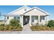 Charming single-story home featuring a covered porch with columns and a beautifully landscaped front yard at 7621 Highgrove Ave, Bradenton, FL 34210