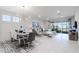 Bright and airy living and dining space with stylish furniture, shiplap accent wall and sliding glass doors to the outside at 7621 Highgrove Ave, Bradenton, FL 34210