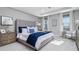 Bright main bedroom boasts tray ceilings, plush carpeting, and a luxurious upholstered headboard for ultimate relaxation at 7621 Highgrove Ave, Bradenton, FL 34210