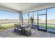 Screened patio offers outdoor dining with a view, showcasing a dining set and comfortable seating at 7621 Highgrove Ave, Bradenton, FL 34210