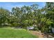 Overlooking a canal with mature trees and a grassy backyard at 9107 Brunswick Ln, Tampa, FL 33615