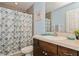 Bathroom with shower/tub combo, vanity, and blue and gray color scheme at 9107 Brunswick Ln, Tampa, FL 33615
