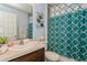 Bathroom with modern patterned shower curtain, decorative fish art, and ample counter space at 9107 Brunswick Ln, Tampa, FL 33615