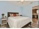 Comfortable bedroom connected to a kitchen view, featuring a queen-sized bed and side table at 9107 Brunswick Ln, Tampa, FL 33615