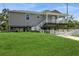 Inviting two-story home with a spacious covered porch and a well-manicured front lawn on a sunny day at 9107 Brunswick Ln, Tampa, FL 33615