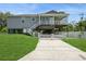 Inviting two-story home with a spacious covered porch and a well-manicured front lawn and white picket fence at 9107 Brunswick Ln, Tampa, FL 33615