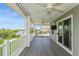 Outdoor deck featuring white railings and tranquil views of a waterway and lush vegetation at 9107 Brunswick Ln, Tampa, FL 33615