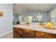 Kitchen features a breakfast bar overlooking the living room, wooden cabinetry at 9107 Brunswick Ln, Tampa, FL 33615