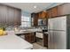 Contemporary kitchen with stainless steel appliances, tile backsplash, and ample counter space at 9107 Brunswick Ln, Tampa, FL 33615