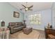 Cozy living room with neutral walls, modern ceiling fan, and comfortable seating area at 9107 Brunswick Ln, Tampa, FL 33615