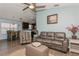 Open-concept living room featuring light blue walls, modern ceiling fan, and comfortable seating area at 9107 Brunswick Ln, Tampa, FL 33615
