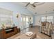 Bright living room with vaulted ceiling, sliding glass doors, and stylish decor at 9107 Brunswick Ln, Tampa, FL 33615