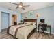 Comfortable bedroom featuring a ceiling fan, en-suite bath, and a desk area at 9107 Brunswick Ln, Tampa, FL 33615