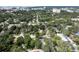 Wide aerial view of a residential neighborhood with mature trees, streets, and distant views of city buildings at 921 Grand Central St, Clearwater, FL 33756