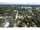 Expansive aerial view showcasing a neighborhood near a lake, surrounded by lush greenery and mature trees at 921 Grand Central St, Clearwater, FL 33756