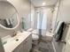 Bathroom featuring stylish white and gray marble-like tile, a modern vanity, and updated fixtures at 921 Grand Central St, Clearwater, FL 33756