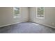 A neutral bedroom with carpet and dual windows for ample natural light at 921 Grand Central St, Clearwater, FL 33756