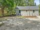 Exterior view of a single-story home showcasing the neutral siding, clean lines, and low maintenance landscaping at 921 Grand Central St, Clearwater, FL 33756