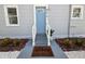 Charming home featuring a light blue front door, fresh landscaping, and a welcoming entrance at 921 Grand Central St, Clearwater, FL 33756