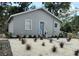 Inviting home with a freshly painted exterior, complemented by a manicured gravel yard and charming blue front door at 921 Grand Central St, Clearwater, FL 33756