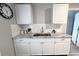 Updated kitchen featuring white cabinets, subway tile backsplash, and modern faucet at 921 Grand Central St, Clearwater, FL 33756