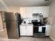 A functional kitchen with stainless steel appliances, white cabinets, and ample counter space at 921 Grand Central St, Clearwater, FL 33756